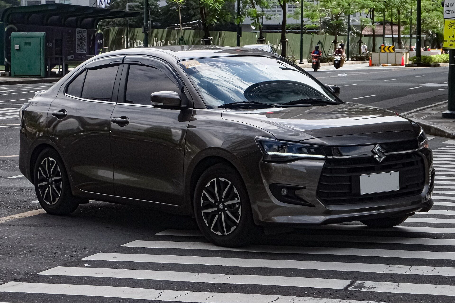 Grey 2025 Suzuki Dzire, front three-quarter view