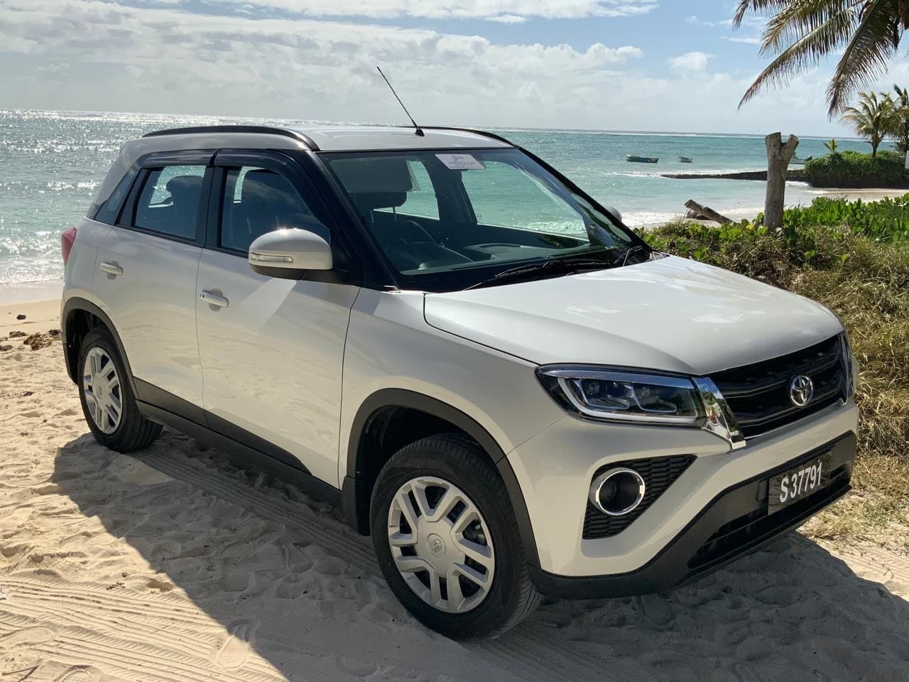 White Toyota Urban Cruiser parked on a beach in Seychelles